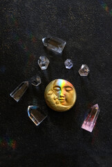 clear quartz minerals and symbolic moon amulet close up on dark abstract background. Witchcraft,...