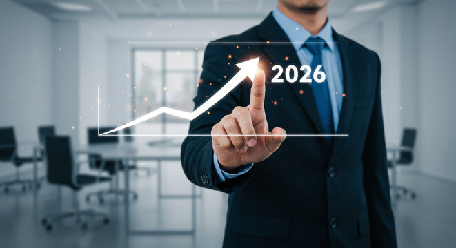 Confident businessman visualizing 2026 growth strategy with upward trend graph in modern office, forecasting success and positive business outlook