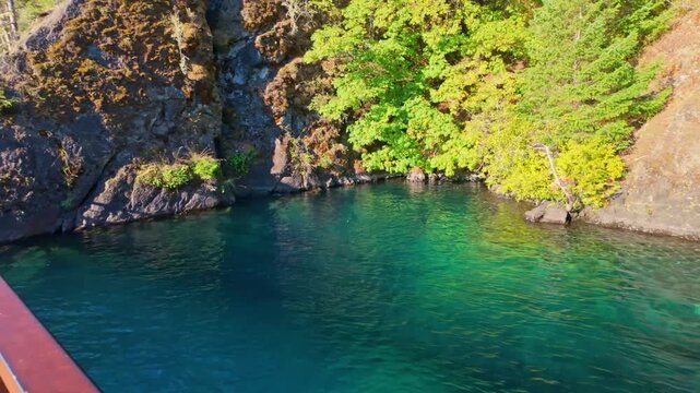 A beautiful view of the clear waters at Devil's Punchbowl, a famous landmark on Lake Crescent in Olympic National Park