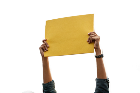 se-up of a hand holding up yellow paper. Cutout. Transparent. Message. Protest. Demonstration. Opinion. Statement.