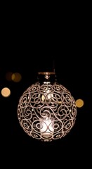 Ornate Metal Lantern Illuminating the Darkness with Intricate Design.