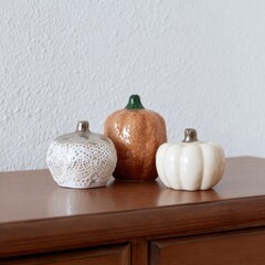 Decorative Ceramic Pumpkins on Wooden Surface for Fall Season Decor