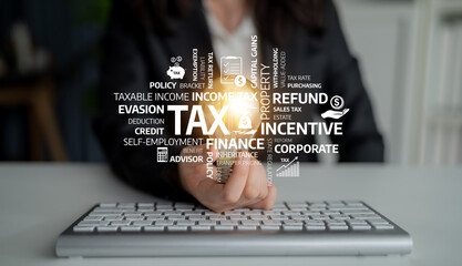 A close-up view of a hand on a keyboard with highlighted financial terms related to tax and...