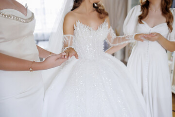 Wedding dress fitting with bridal party at a bridal boutique in the morning