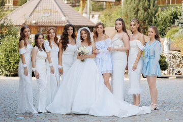 Bridal party gathers outside for joyful wedding celebration in a scenic garden setting
