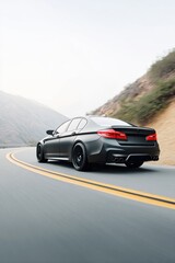 Obraz premium Matte black sedan navigating a winding serpentine road, showcasing sleek design and dynamic movement in a scenic mountainous landscape with soft lighting