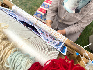 Carpet weaving using traditional techniques on a loom. , close-up of weaving and handmade carpet production.