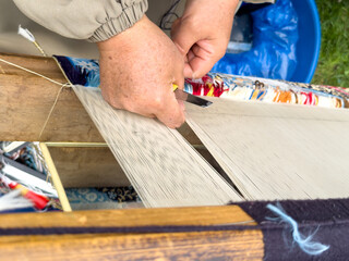 Carpet weaving using traditional techniques on a loom. , close-up of weaving and handmade carpet production.