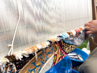 Carpet weaving using traditional techniques on a loom. , close-up of weaving and handmade carpet production.