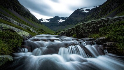 Serene Mountain Stream Waterfall Flowing Through Lush Green Valley.