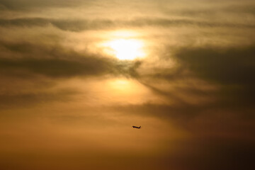 Fototapeta premium Airplane Silhouette Against Sunset Sky