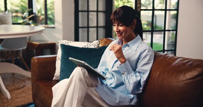 Reading, smile and woman on sofa with tablet, email check or funny post on online app. Digital, laughing and female person in house with technology, entertainment or meme reaction on social media.