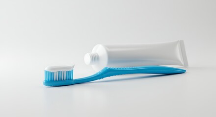 Close-up of a blue toothbrush with white toothpaste on its bristles and a white toothpaste tube on a clean white background.