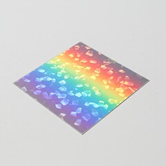 Iridescent holographic square sticker with a dazzling rainbow spectrum and sparkling glitter effect on a clean white background showcasing a vibrant