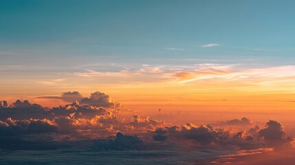 Obraz premium Breathtaking Sunrise Over Soft Clouds Illuminated by Golden Light in a Calm Sky Captured from Above, Perfect for Serenity and Nature Inspired Themes