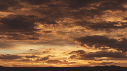 Fototapeta premium Dramatic Sunset Over a Serene Landscape with Vibrant Clouds and Golden Hues Casting a Beautiful Reflection on the Horizon in Early Evening
