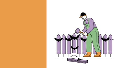 Man hammering bats onto a picket fence for Halloween decoration DIY spooky home improvement
