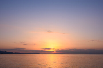 Fototapeta premium Serene Sunset Over Calm Ocean