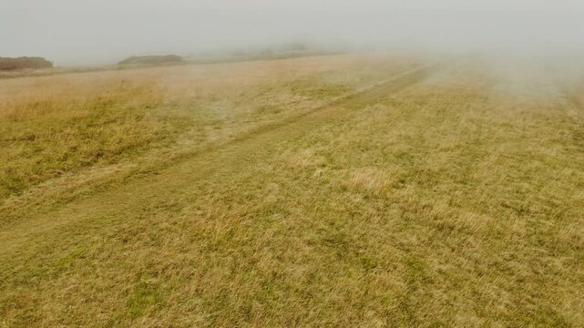 The stunning cliffs of Eastbourne enshrouded in mist, East Sussex, England, UK, with chalk faces fading into low cloud along the Channel coast