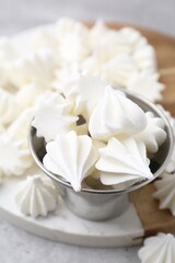 Delicious meringue cookies on grey table, closeup