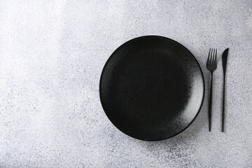 Stylish plate and cutlery on grey table, flat lay. Space for text