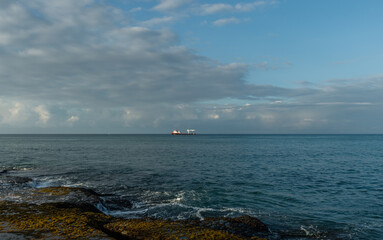 Scenic west Oahu vista at sunrise with a ship in the background, Hawaii