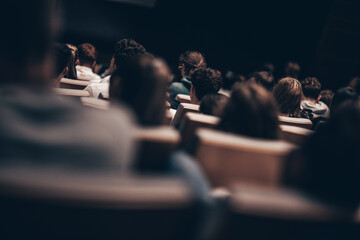 Rear view of unrecognizable people in audience at the conference hall. Business and entrepreneurship symposium