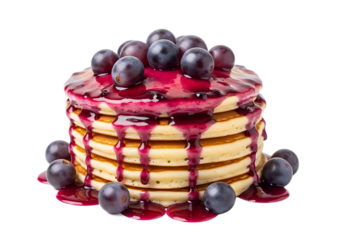 stack of pancakes with purple grape sauce and fresh whole grapes on the top