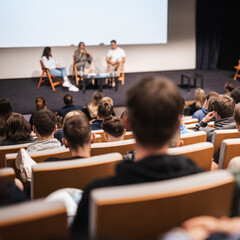 Interview and round table discussion at business convention and presentation. Audience at the conference hall. Business and entrepreneurship symposium.