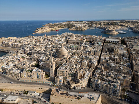 Malta Valletta city skyline panorama with historic Fort St Elmo and Grand Harbour aerial drone view.
