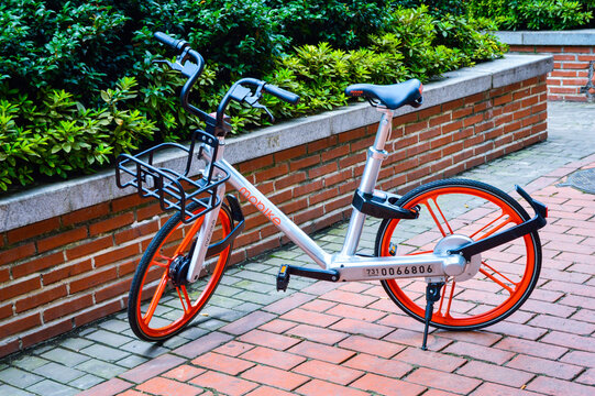 Changsha, China, July, 2017.  A orange-color bike on the street, the bike-sharing operated by Mobike.