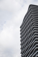 Modern Residential High-Rise with Geometric Balconies Against Blue Sky