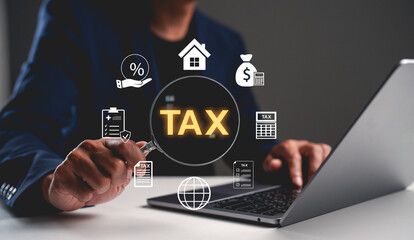 A person working on a laptop with tax-related graphics, including symbols for money, home, and calculations, emphasizing financial management.