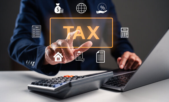 A person using a calculator and laptop, engaging with digital tax icons, emphasizing financial analysis and tax management. - Powered by Adobe