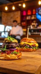 Two gourmet burgers on a wooden surface