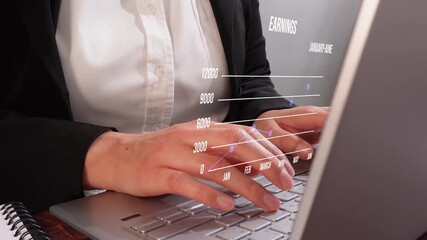 Concentrated female executive hands working on her laptop with an animation of a half-yearly earnings chart - Powered by Adobe