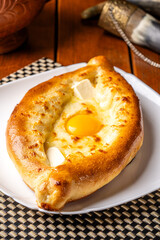Traditional georgian khachapuri adjaruli with egg and cheese