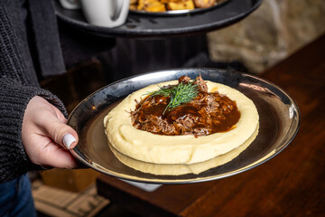 Mashed potatoes with braised beef and gravy