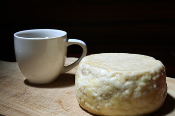 Brazilian breakfast, typical cheese from minas gerais, brazil and coffee cup.