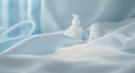 Soft blue fabric and white dispenser bottle