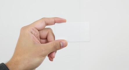 Fototapeta premium Card Mockup Held in Hand Against White Background