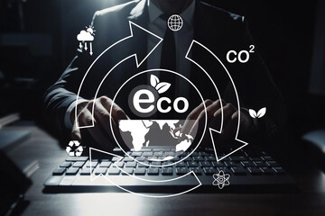 Businessman Typing on Keyboard with Eco-Friendly Icons Representing Sustainability, Carbon...