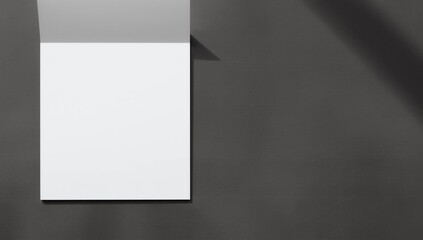 Blank paper sheet on dark grey background, top view. Mock up for design