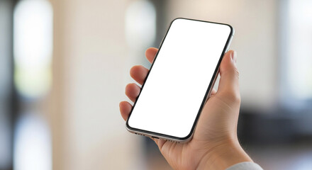A hand delicately holds a modern smartphone with a pristine white screen, set against a softly blurred background, inviting focus on the devices sleek design