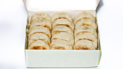 Bakpia is a flat, round cake made from a mixture of chocolate and sugar, wrapped in flour dough, and baked. It's a popular souvenir from Yogyakarta.