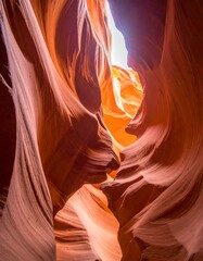 Intricate sandstone canyon walls with light filtering through the opening