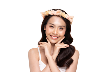 Asian Smiling young woman with floral headband and folded hands framing her face, soft makeup and long dark hair, studio portrait with cheerful and graceful expression