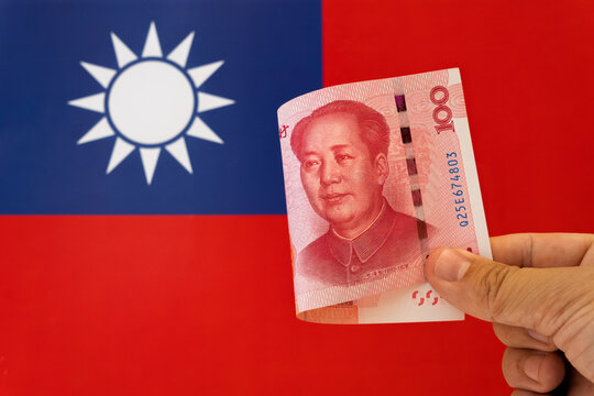 a hundred yuan bill on the background of the flag of the Taiwan. concept of developing China's financial relations with other countries. Chinese financial investments and assistance.