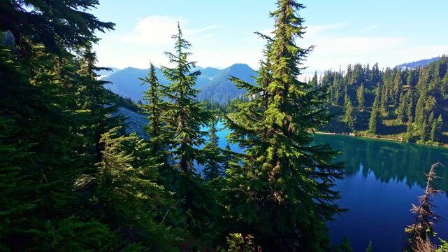 A breathtaking view of the vibrant blue waters of Lake Valhalla, nestled amidst the stunning wilderness of Washington and part of the iconic Pacific Crest Trail