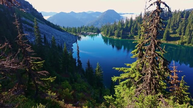 A breathtaking view of the vibrant blue waters of Lake Valhalla, nestled amidst the stunning wilderness of Washington and part of the iconic Pacific Crest Trail